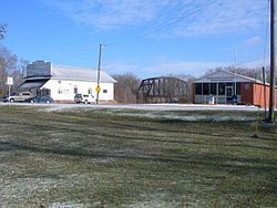 Store and post office in Dahinda with BNSF Railway steel bridge in background