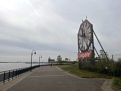 The clock and the bench at its foot. Visible in the background are the Central Railroad of New Jersey Terminal and the Statue of Liberty.