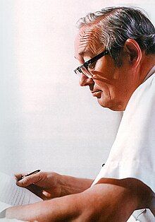 Office portrait, D. Jamison Cain reviewing typewritten writing in his office at US Postal Service Headquarters, L'Enfant Plaza, Washington DC, ca 1980