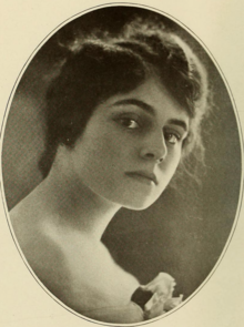 A young white woman with dark hair, in an oval frame