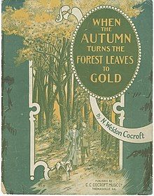 Sheet music for "When the Autumn Turns the Forest Leaves to Gold" (1909) by N. Weldon Cocroft; illustration in greens and golds of a white couple standing in a forest with a dog.