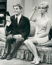 Robert Morse as Robert Dickson (left) and E. J. Peaker as Gloria Quigley Dickson (right)