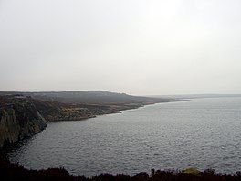 A lake with a rocky shoreline