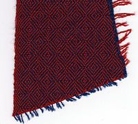 Diamond twill, with weaving edge (left), blue warp, red weft