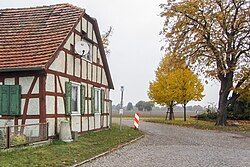 Prussian round base stone in front of Dorfstrasse, Schwarzholz