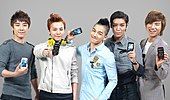 Big Bang smiling for the camera while holding LG cellphones