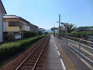 A view of the station platform and track. The ramp from the station building can be seen on the right.