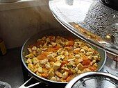 Cooking jasha maru, a traditional dish consisting of minced chicken, tomatoes, and other ingredients