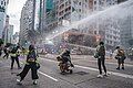 Police water cannon vehicles fired water jets on Hennessy Road in Wan Chai to disperse crowds and reporters.