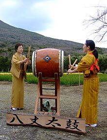 Two women wearing kimonos perform traditional Hachijō-daiko.