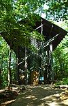 Front of the Thorncrown Chapel partially obscured by trees