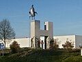 A rooster statue on a roundabout