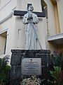 A statue of St. Pedro Bautista next to the original façade