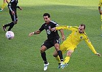 Rich Balchan defends a ball against Dwayne De Rosario during a match at Columbus Crew Stadium