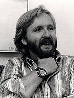 James Cameron in 1986. He has a full beard and wearing a Rolex watch on his wrist