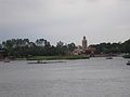 The Morocco pavilion as seen from across World Showcase Lagoon; The Twilight Zone Tower of Terror, whose top is designed to blend in with the pavilion, can be seen beyond the treetops.