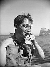 photo of man wearing diving gear smoking