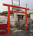 Another view of the station entrance. The concrete structure behind the torii is not the station building but a toilet.