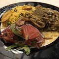 Guanta stew with red rice, salad and patacones