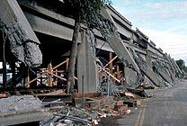 The collapsed Cypress Street Viaduct seen from ground level. Note the detachment of upper vertical elements from lower and the lack of reinforcement at the point of detachment.