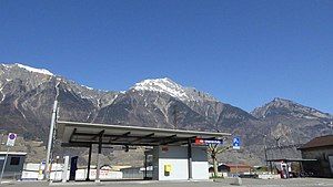 Canopy-covered platform shelter with mountains in the distance