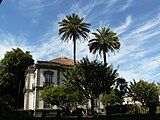 The mansion surrounded by gardens.