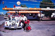 picture of Juan Delgadillo standing next to his 1936 Chevrolet