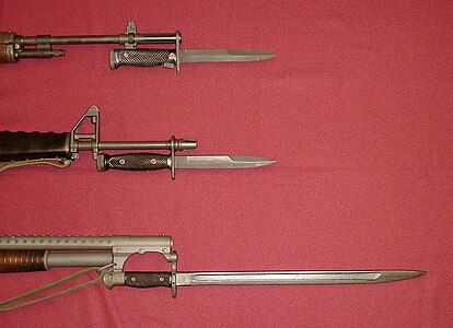 U.S. military bayonets of the Vietnam War. Top: M6 bayonet affixed to the M14 rifle. Center: M7 bayonet affixed to the M16A1 rifle. Bottom: M1917 bayonet affixed to the Winchester model 12 combat shotgun.