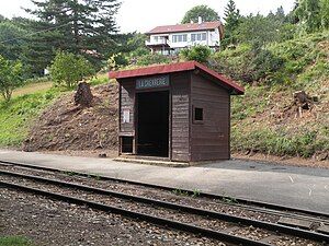 Wooden station shelter next to railway line