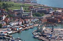 A view of Old Portsmouth taken from the viewing deck of the Spinnaker Tower. Old buildings, cobbled streets and a small island can be seen in the frame.