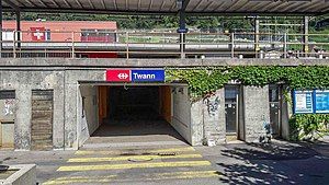 Pedestrian underpass beneath canopy-covered platforms