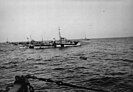 A liferaft carrying survivors from U-546 in the midst of a group of U.S. Navy destroyer escorts on April 24, 1945