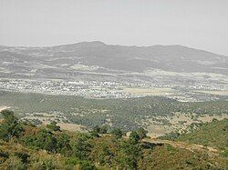 Guelma Valley as seen from Ben Djerrah, partially showing the metropolitan area of Guelma with the cities of Boumahra Ahmed, Belkheir, and Guelma visible (from right to left/east to west)