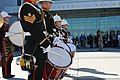 Closeup of buglers from the Band of HM Royal Marines Scotland performing in front of the National Museum of the Marine Corps, 2009.