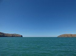 Godley Head (left) and Te Piaka / Adderley Head (right), as seen from Lyttelton Harbour / Whakaraupō