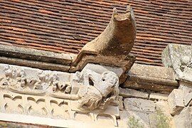 Detail of another marmouset sculpture with a simple gargoyle above.