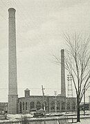 A one-story brick powerhouse with two chimneys