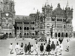 A photo of Victoria Terminus from 1910. Note the seated statue in the canopy under the clock