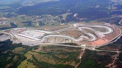 Istanbul Park is in a rural area and is paved with tarmac. It has large concrete and gravel run-off areas, large grandstands, and a substantial pit building and paddock.