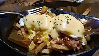 Poutine topped with eggs benedict