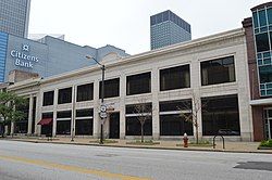 Image of a cream-colored two-story rectangular brick building with garage doors