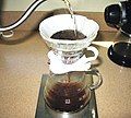 Image 12In a pour-over, the water passes through the coffee grounds, gaining soluble compounds to form coffee. Insoluble compounds remain within the coffee filter. (from Coffee preparation)