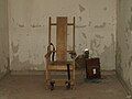 The former execution chamber at the Red Hat Cell Block; the electric chair is a replica of the original Gruesome Gertie