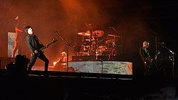 A group of musicians performing on stage in front of a crowd.