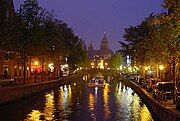 Oudezijds Voorburgwal and silhouette of St. Nicholas' Basilica by night