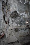 The bathhouse features architectural projections and protrusions designed to hold various items. These built-in elements were likely used to store or place personal belongings, bathing supplies, or other objects during the use of the facility.