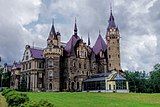 Moszna Castle with an adjoining hothouse