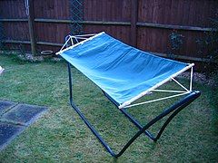 Hammock on a frame in a residential backyard