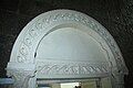 Details of a concrete arch doorway leading to the sacristy