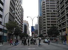 Three lane each way street in between office buildings